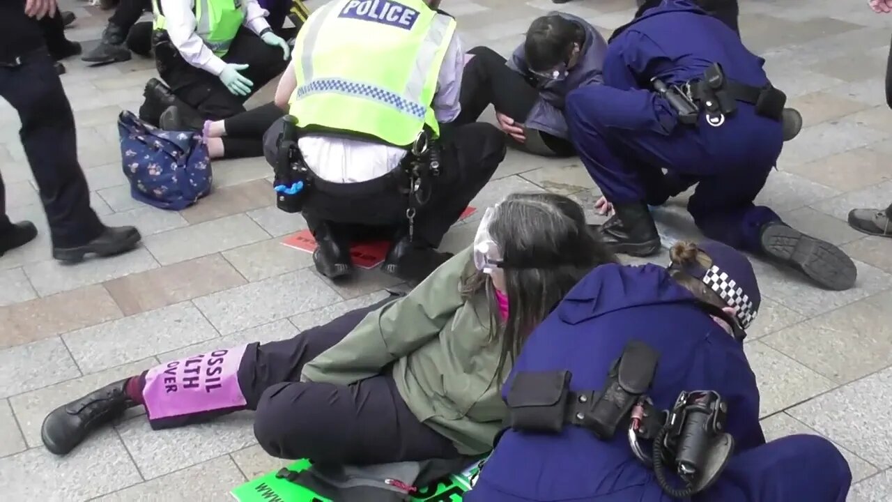 Female police officer removes a women's hand glued to the ground #metpolice