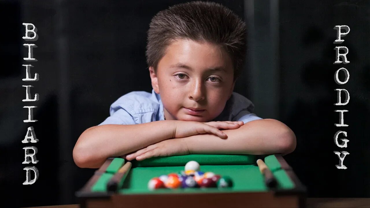 8 Year-old billiard prodigy playing with a mini pool table