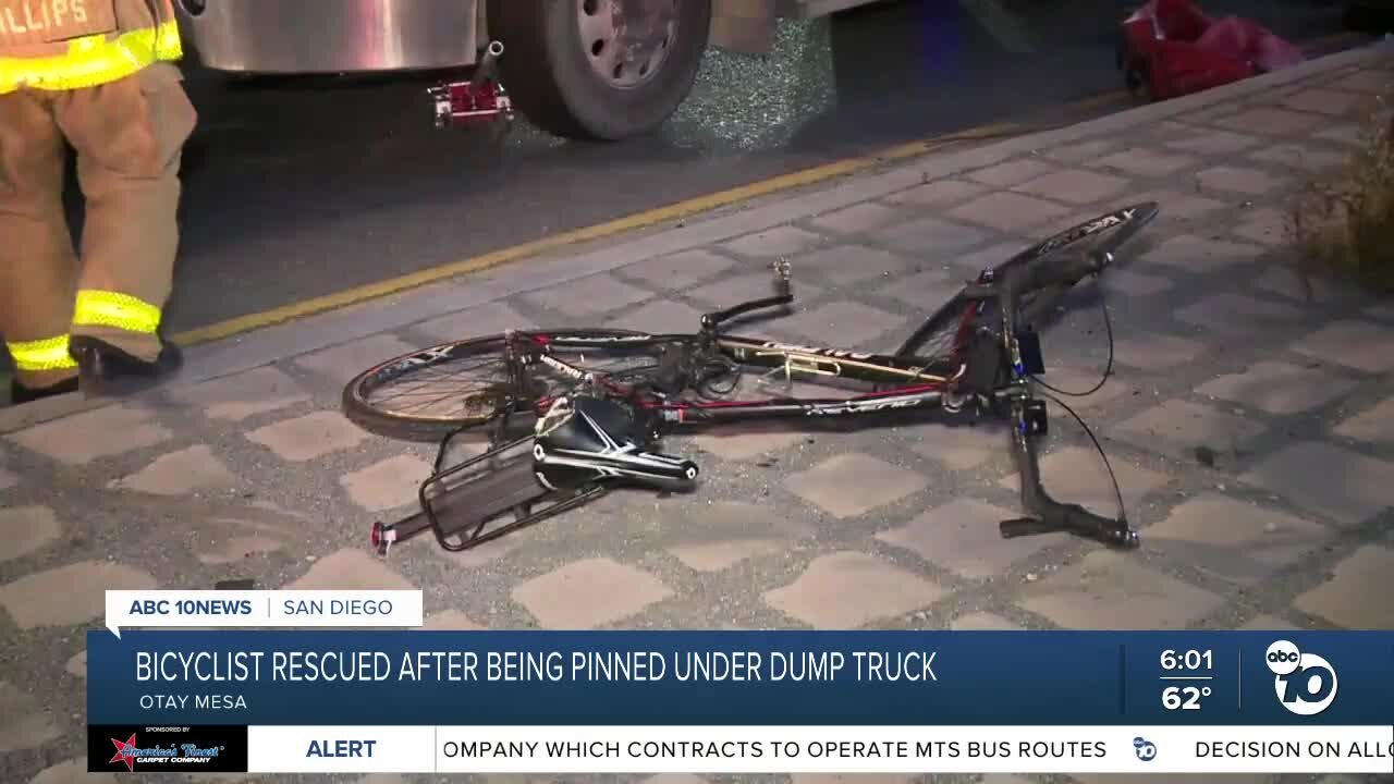 Bicyclist pinned under dump truck, rescued by firefighters