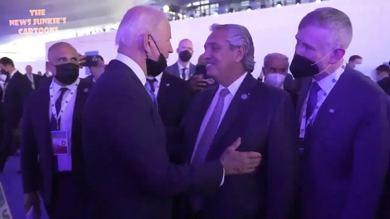 Biden pulls down his mask to get close and talk to Argentinian president.