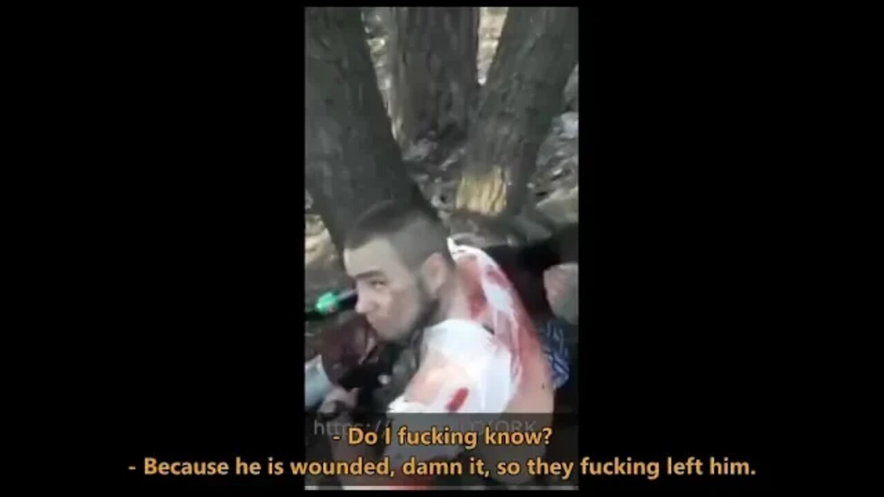 Russian soldiers provide first aid to captive Ukrainian soldiers.