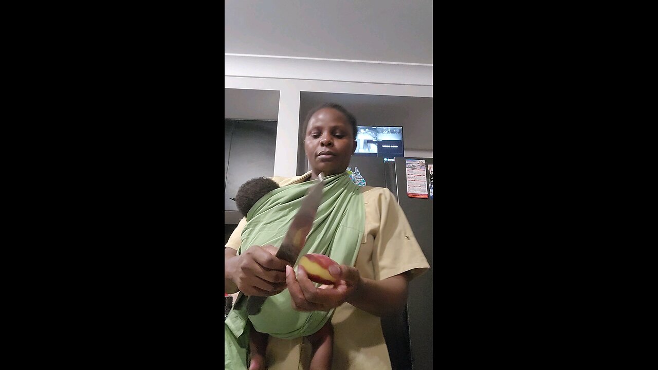 Real african Mama in Austrialia. multitasking is the key. breastfeeding and cooking altogether