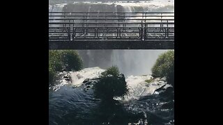 A beautiful waterfall and a bridge with people walking code