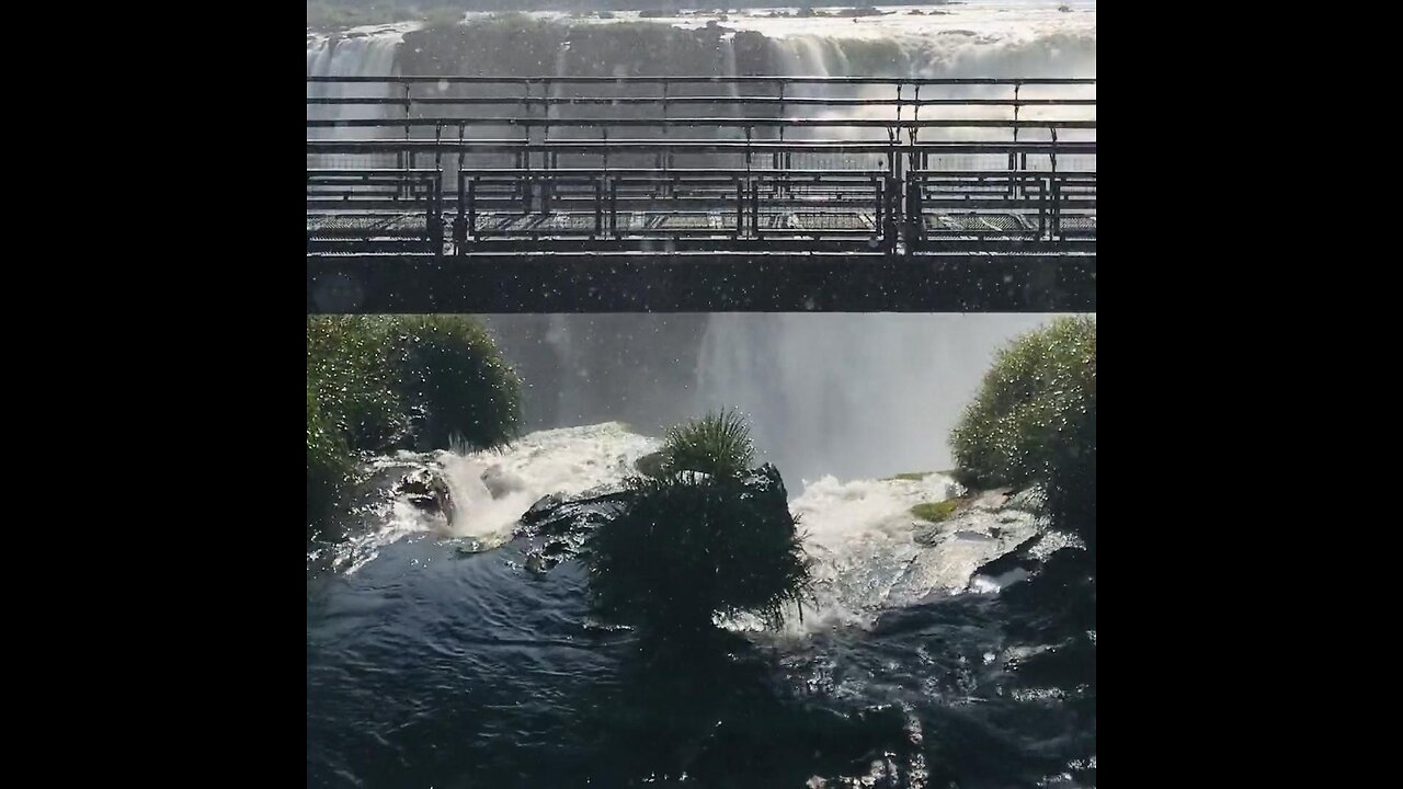 A beautiful waterfall and a bridge with people walking code