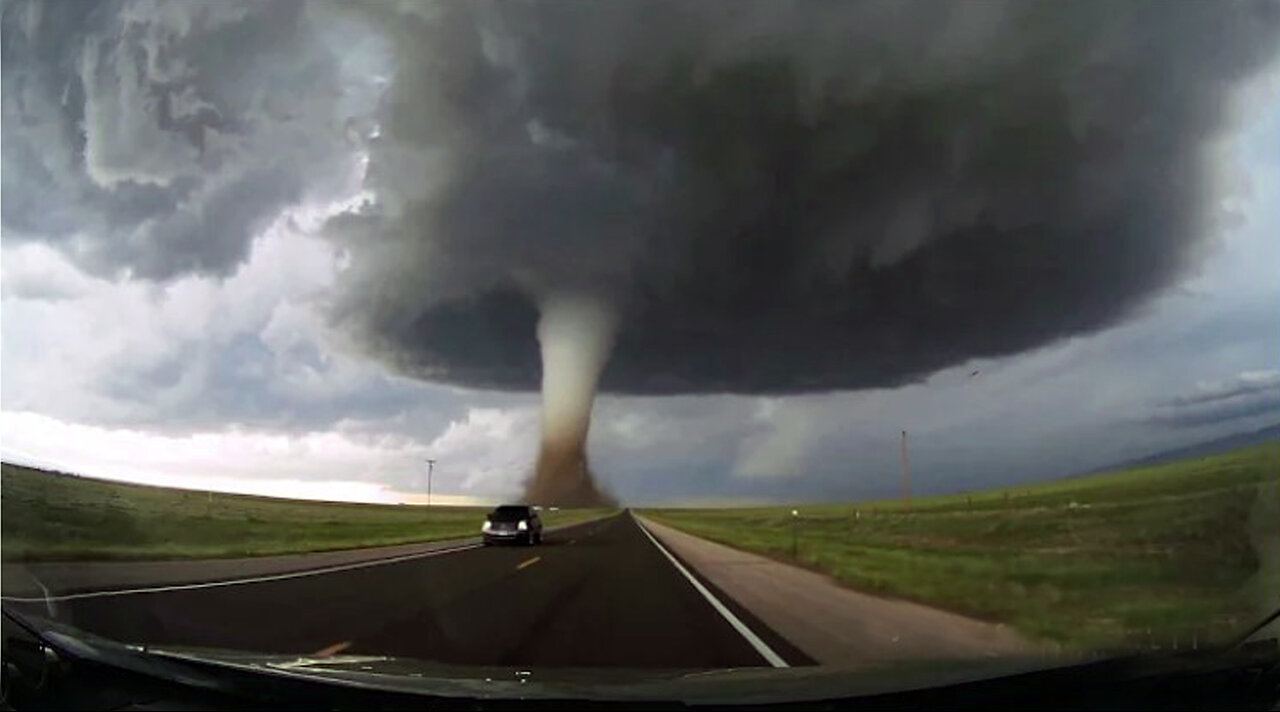 Storm chasing dashcam: Tornado crossing the highway! Laramie, Wyoming