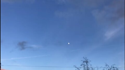 Moon and white lines on sky chemtrails