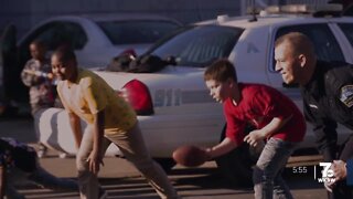 BPD officer playing football with South Buffalo kids captured by local photographer