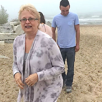 Family Poses For Photo On the Beach, But Mom Doesn’t Hear Them Yelling Until It’s Too Late