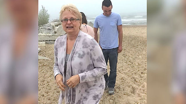 Family Poses For Photo On the Beach, But Mom Doesn’t Hear Them Yelling Until It’s Too Late