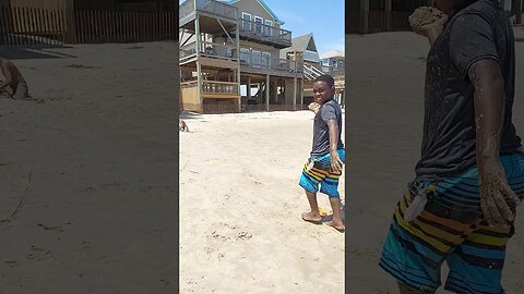 TJ and Milo throw beach sand (i.e. cheeseburgers) on each other