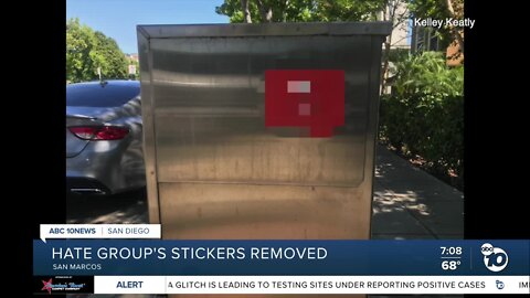 Neighbors quickly rip down white supremacist stickers