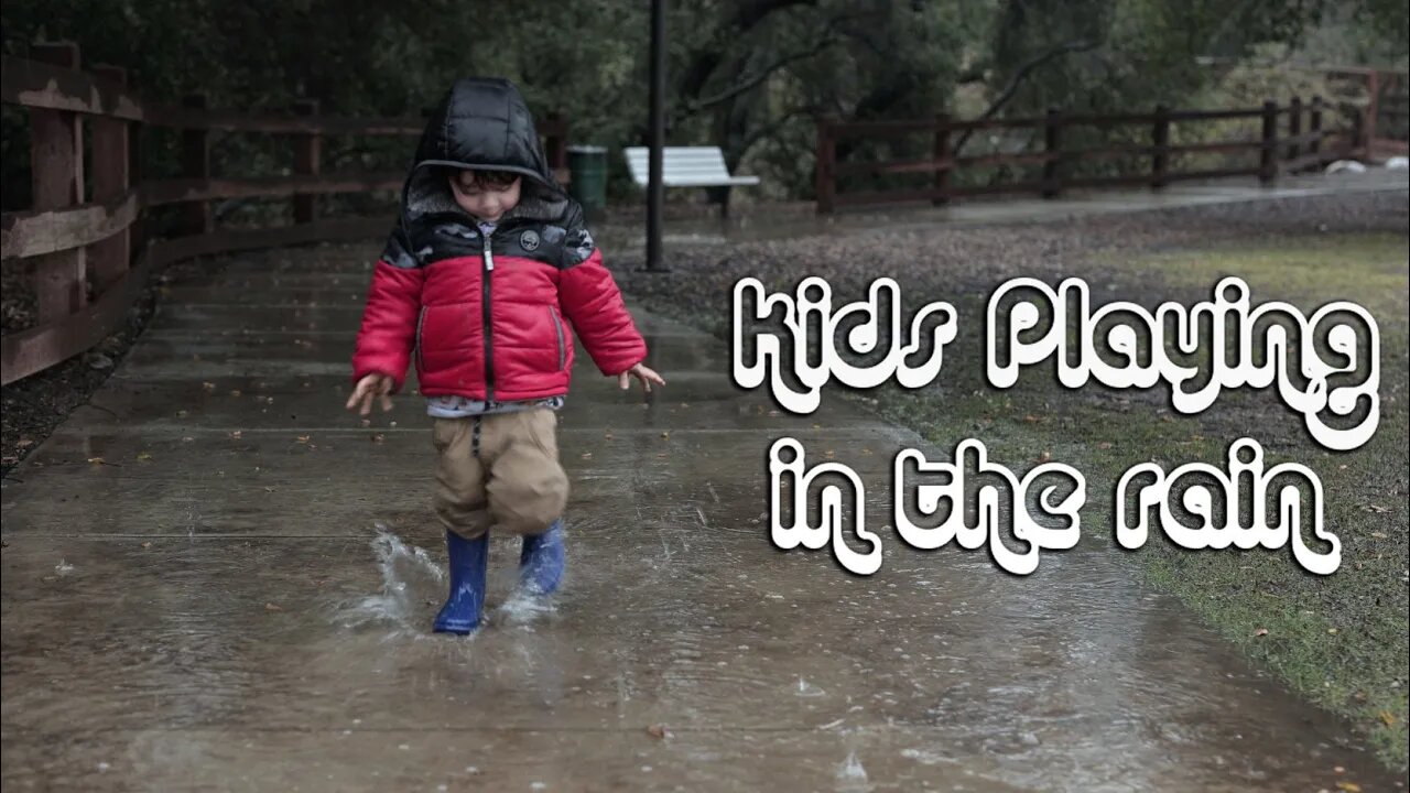 Kid Playing and splashing in the rain