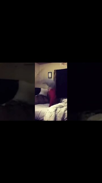 Woman flips on her bed and makes an air raid siren sound