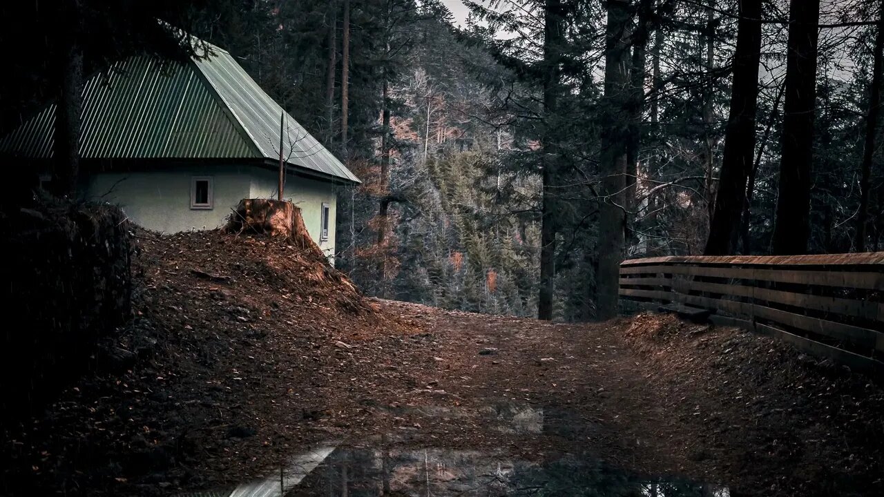 Rain on a tin roof of a house near a gravel path in rural Karpaten