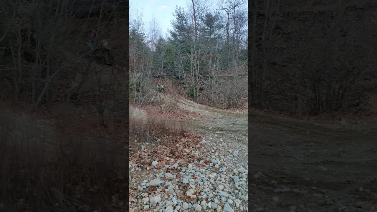 Hitting a small jump on my KLX230 and buddy's Yz450