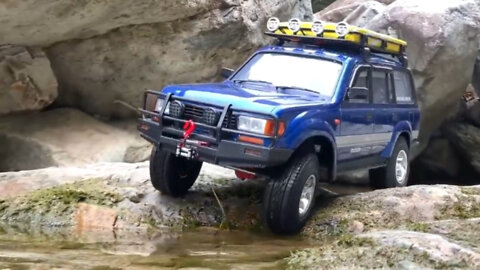 Small and cool. Toyota Land Cruiser overcoming stone and water obstacles. Remote control.