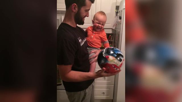 A Baby Boy Laughs At A Bouncing Ball