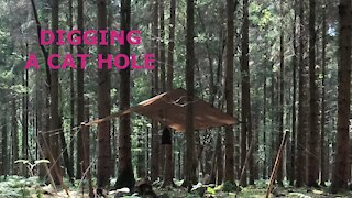 wodland wildcamping digging a cat hole , go pro on a head mount