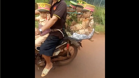 The man carries four small police officers