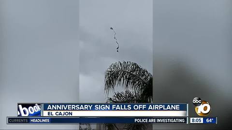 Anniversary sign falls off airplane