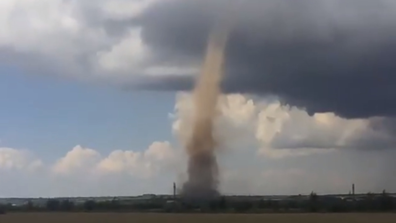 A huge dusty whirlwind in the field