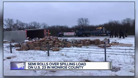 Semi rolls over spilling load on U.S. 23 in Monroe County