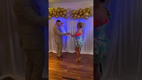 Husband and wife dance at christening