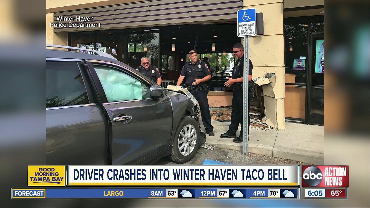 Customer getting more Taco Bell hot sauce avoids being hit when a SUV crashes into the restaurant