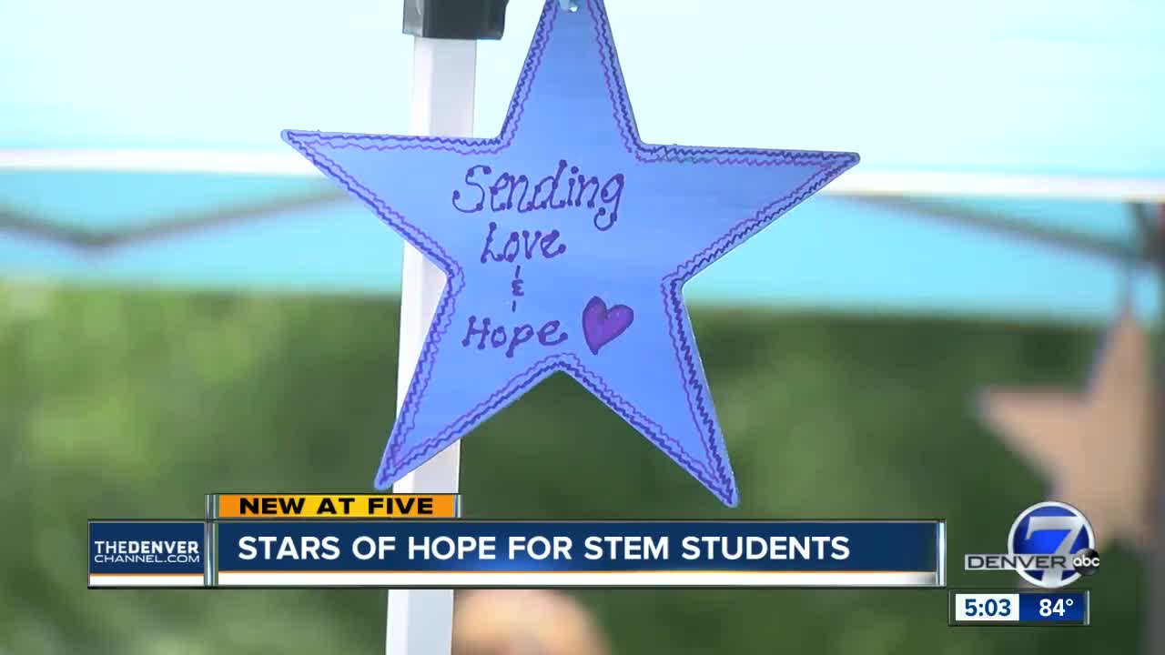 Volunteers paint stars to bring hope to STEM students after tragedy