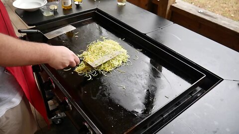 Zucchini and yellow squash noodles with white wine sauce on the Blackstone