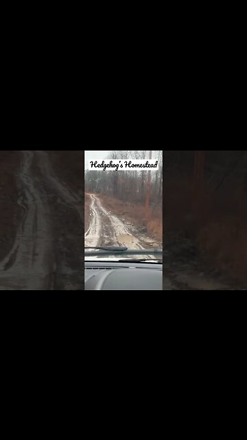 driving on a muddy road in a little Ford escape