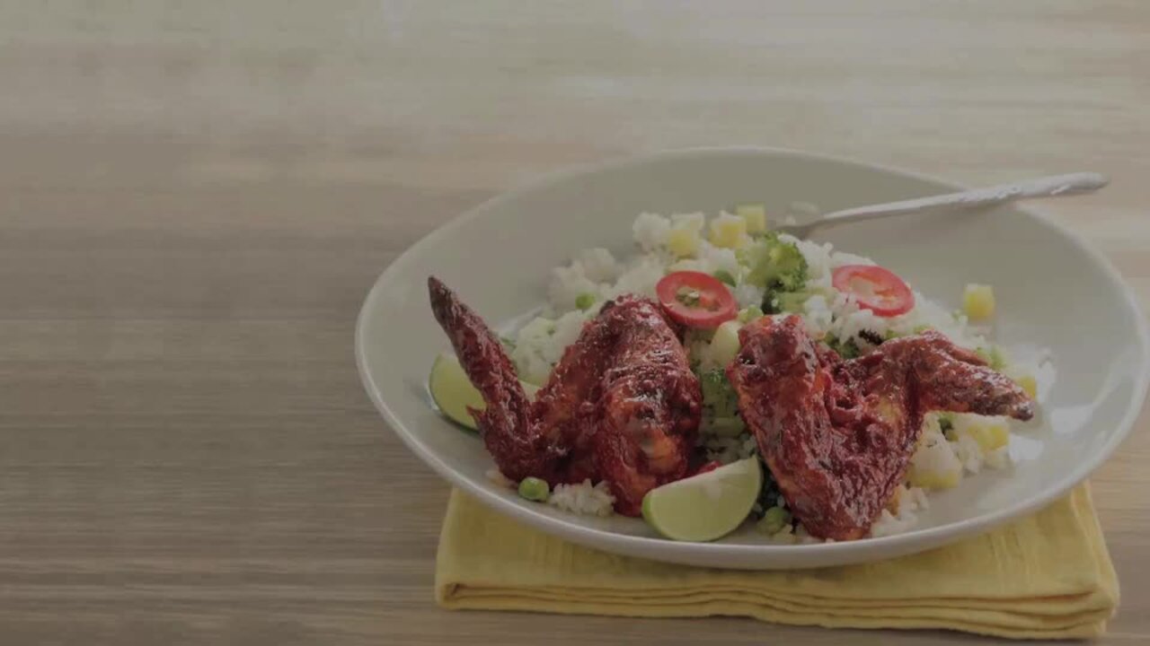 Wings with Annatto and Red Chile on Rice with Vegetables