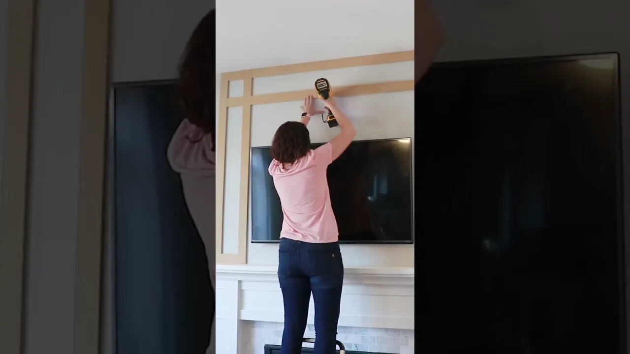 Samantha adding shaker slats to the fireplace wall. #woodworking #diy #shorts