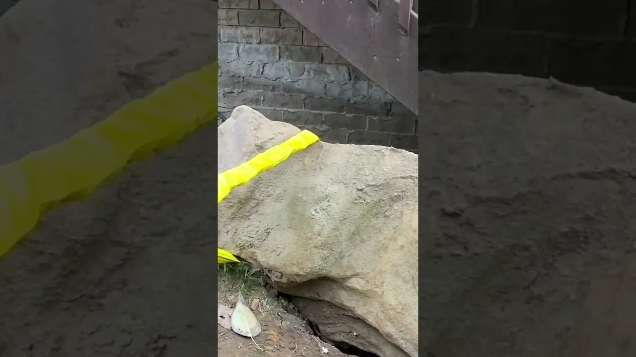 Extracting a boulder from under the stairs