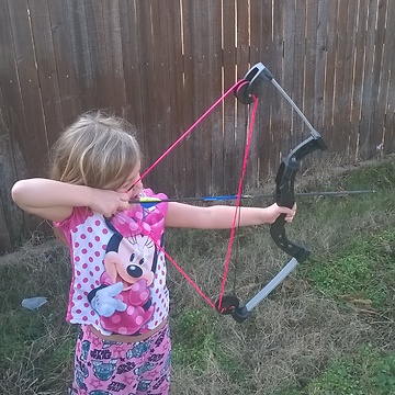 5 Year Old Girl Having Fun With Her Bow