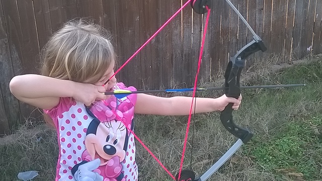 5 Year Old Girl Having Fun With Her Bow