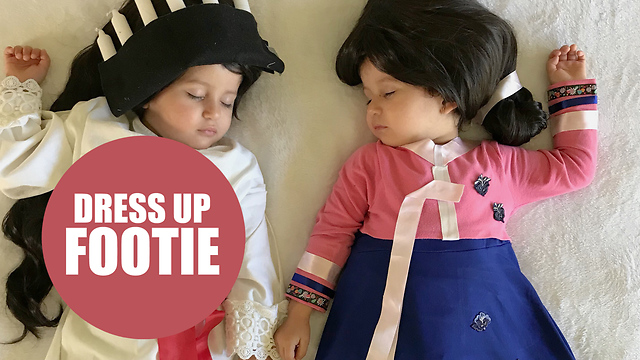 Mother hand makes her twins costumes ready for the WORLD CUP