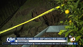 Neighbors worries about deep sinkhole near sidewalk