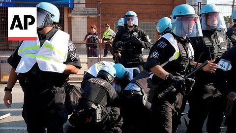 Protesters break through police fence near the DNC