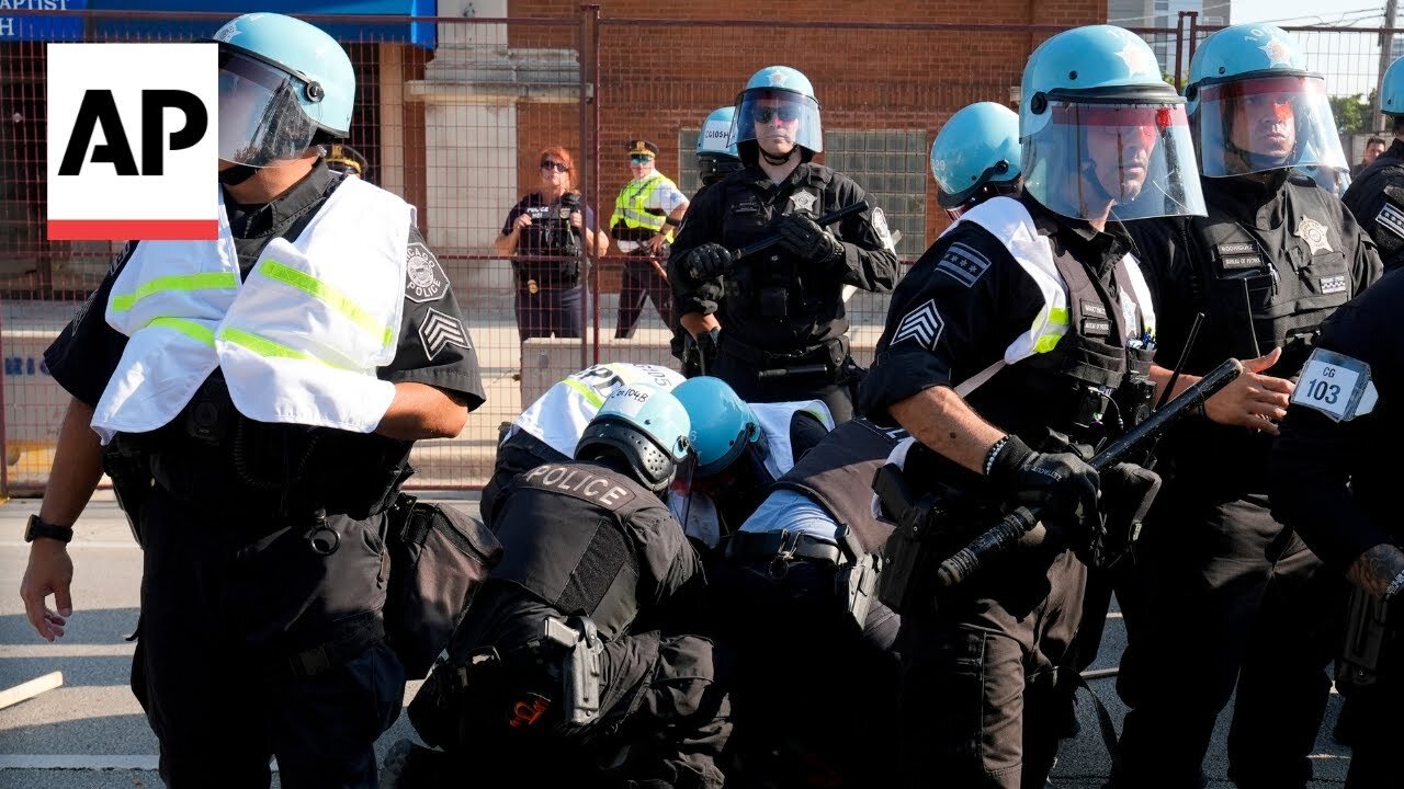 Protesters break through police fence near the DNC