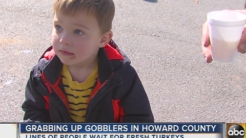 Families line up for fresh turkey at Maple Lawn Farms in Howard County