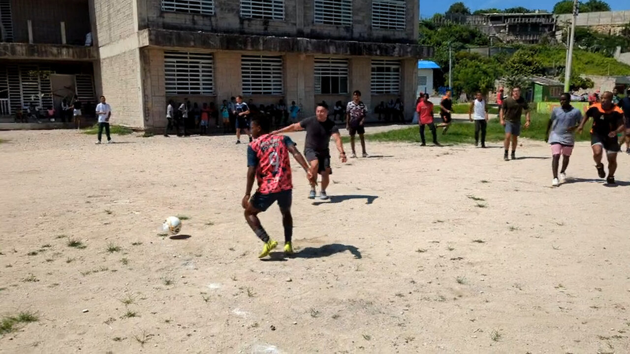 U.S. Sailors, Marines and Colombian Sailors play soccer with students