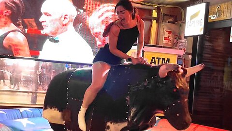 Benidorm Bull Riding_ Girl in a Dress Takes on the Mechanical Bull with Flair