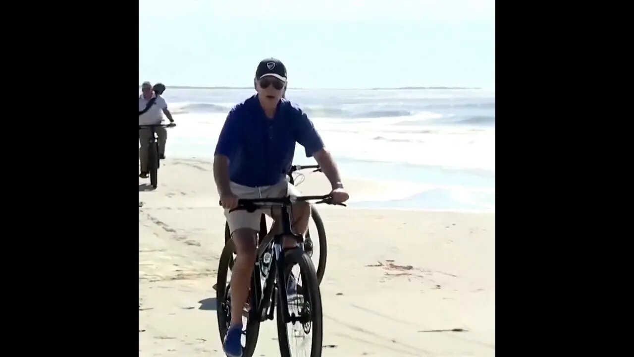 Joe rides his bike on the beach