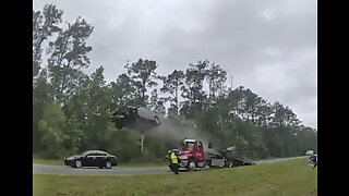 Distracted driver goes AIRBORNE after hitting tow truck! 😳