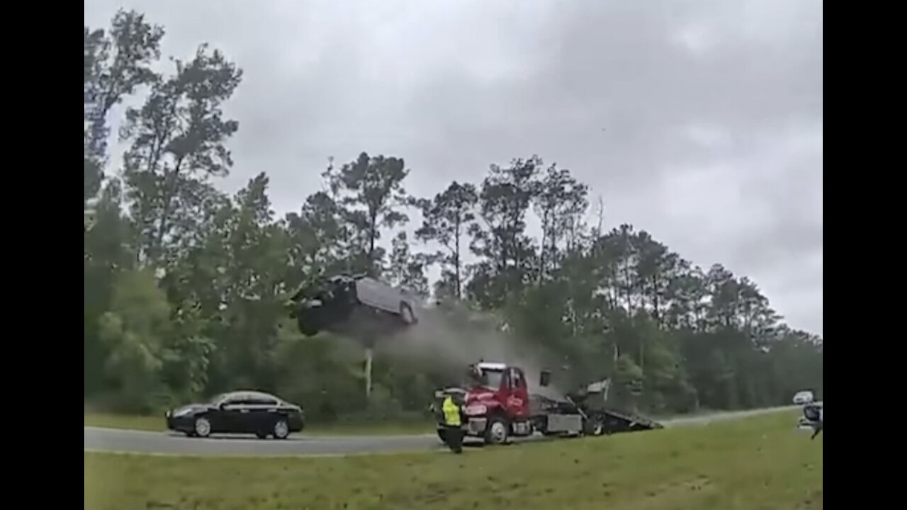 Distracted driver goes AIRBORNE after hitting tow truck! 😳