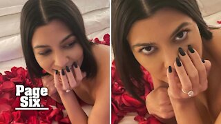 Kourtney Kardashian poses topless to show off engagement ring