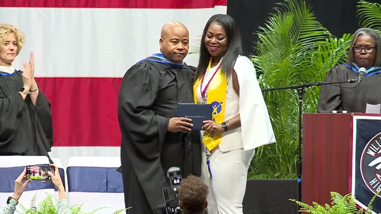 Mother accepts high school diploma for son killed while walking to bus stop