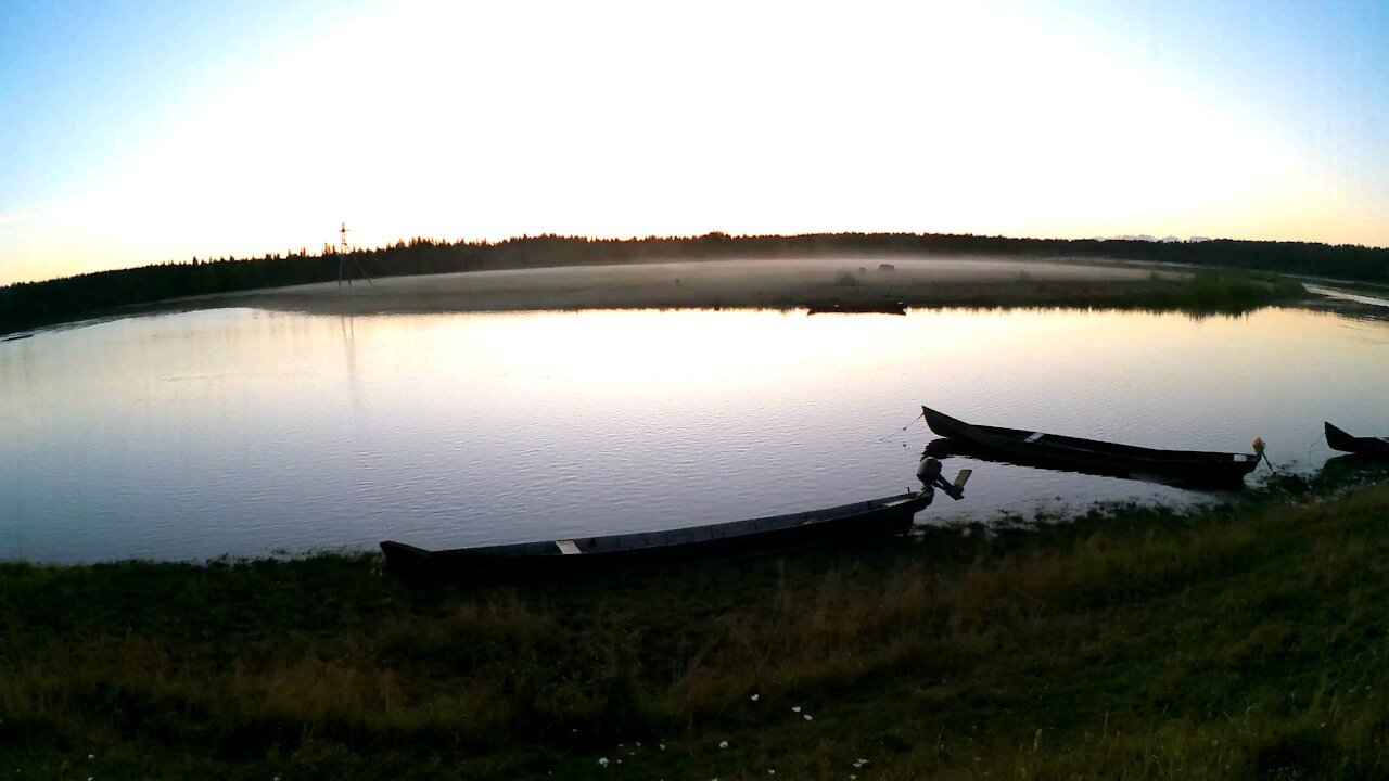 Beautiful sunset, river and fog over the clearing