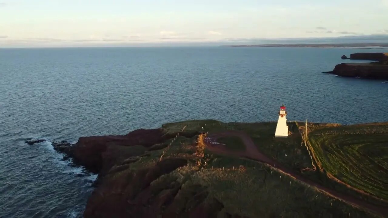 Flying Drone around a Lighthouse at Sunset